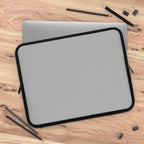 Silver laptop sleeve with black trim, durable neoprene, soft foam lining, dual zipper, lightweight and waterproof protection for laptops