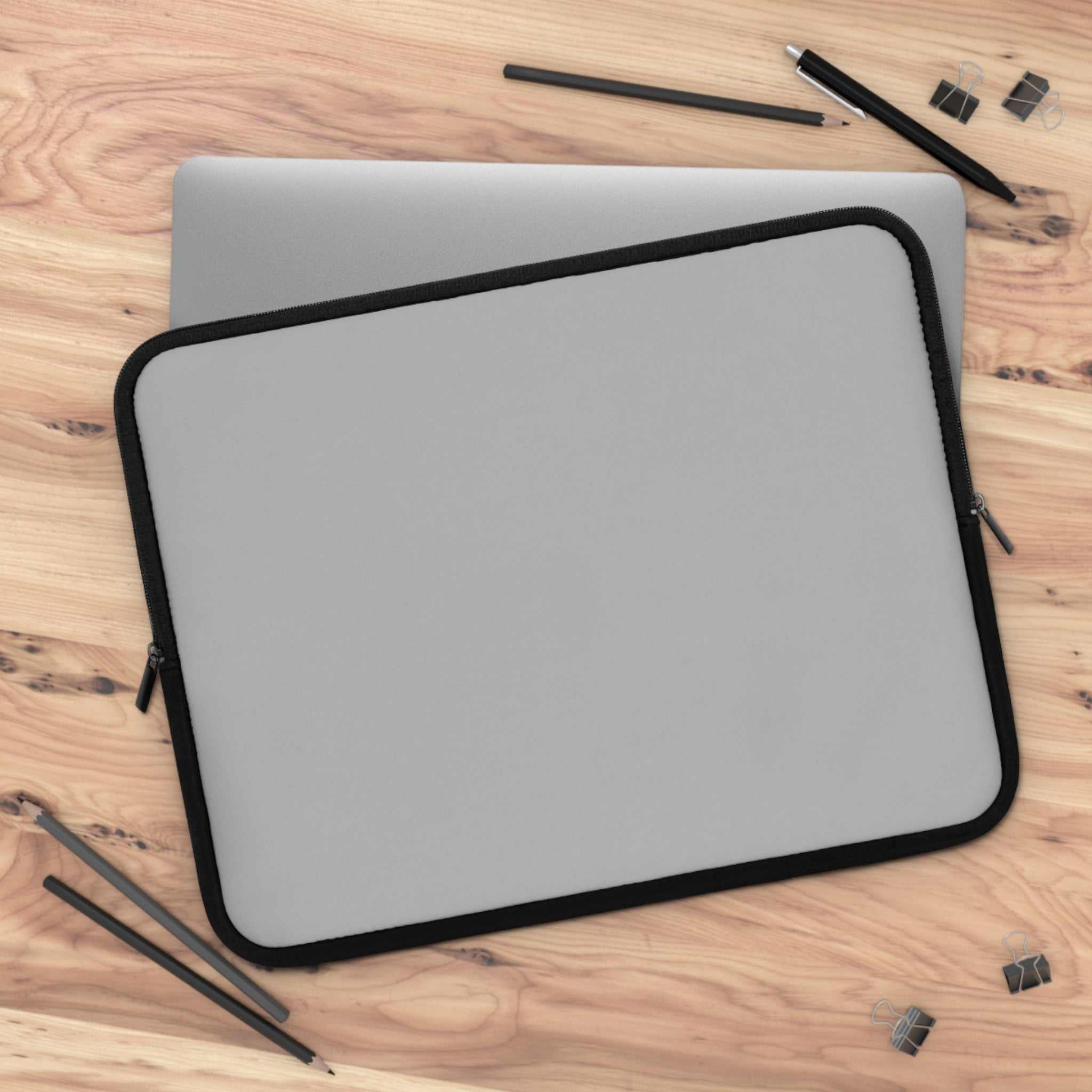 Silver laptop sleeve with black trim, durable neoprene, soft foam lining, dual zipper, lightweight and waterproof protection for laptops