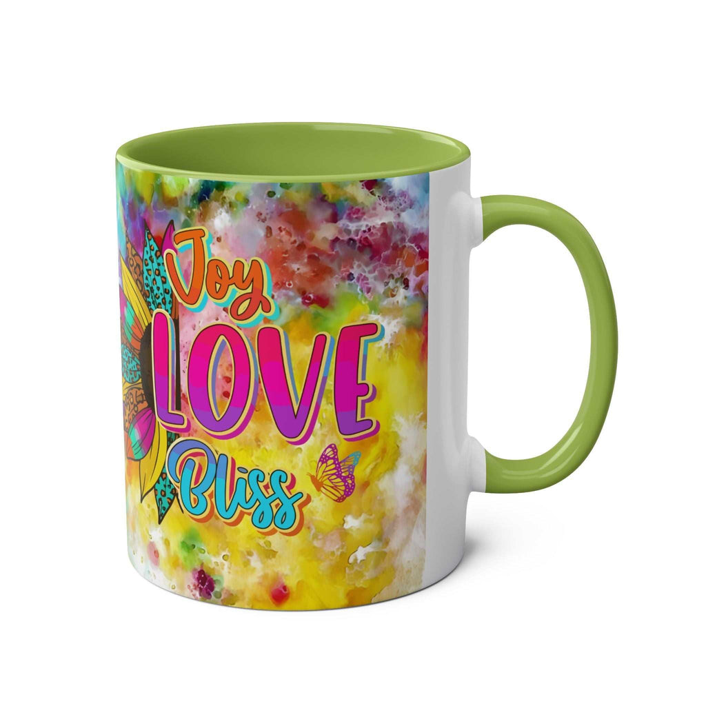 Vibrant LGBTQ+ Pride mug with rainbow and "Joy Love Bliss" design on ceramic.
