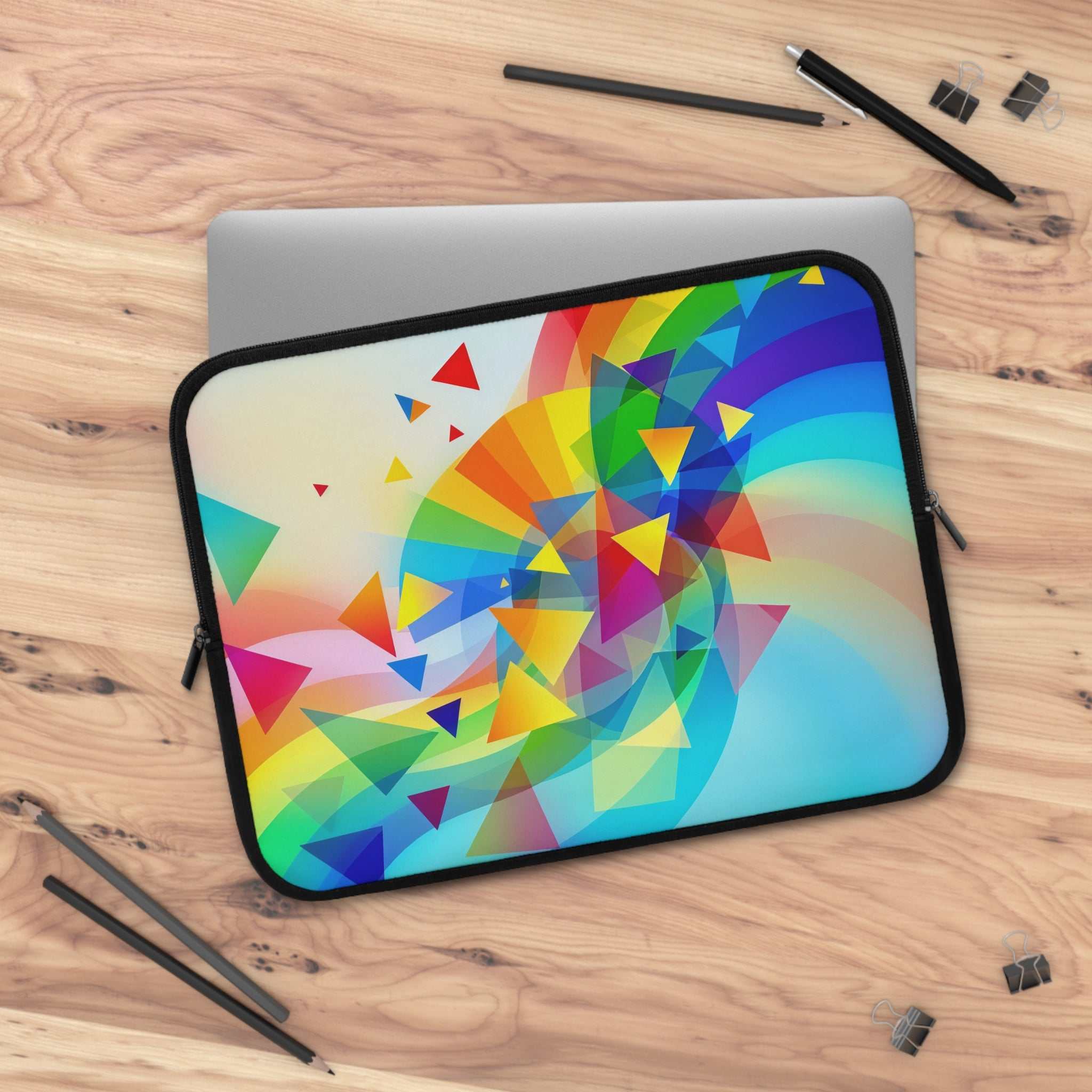 Colorful geometric pride design laptop sleeve with neoprene protection on wooden desk