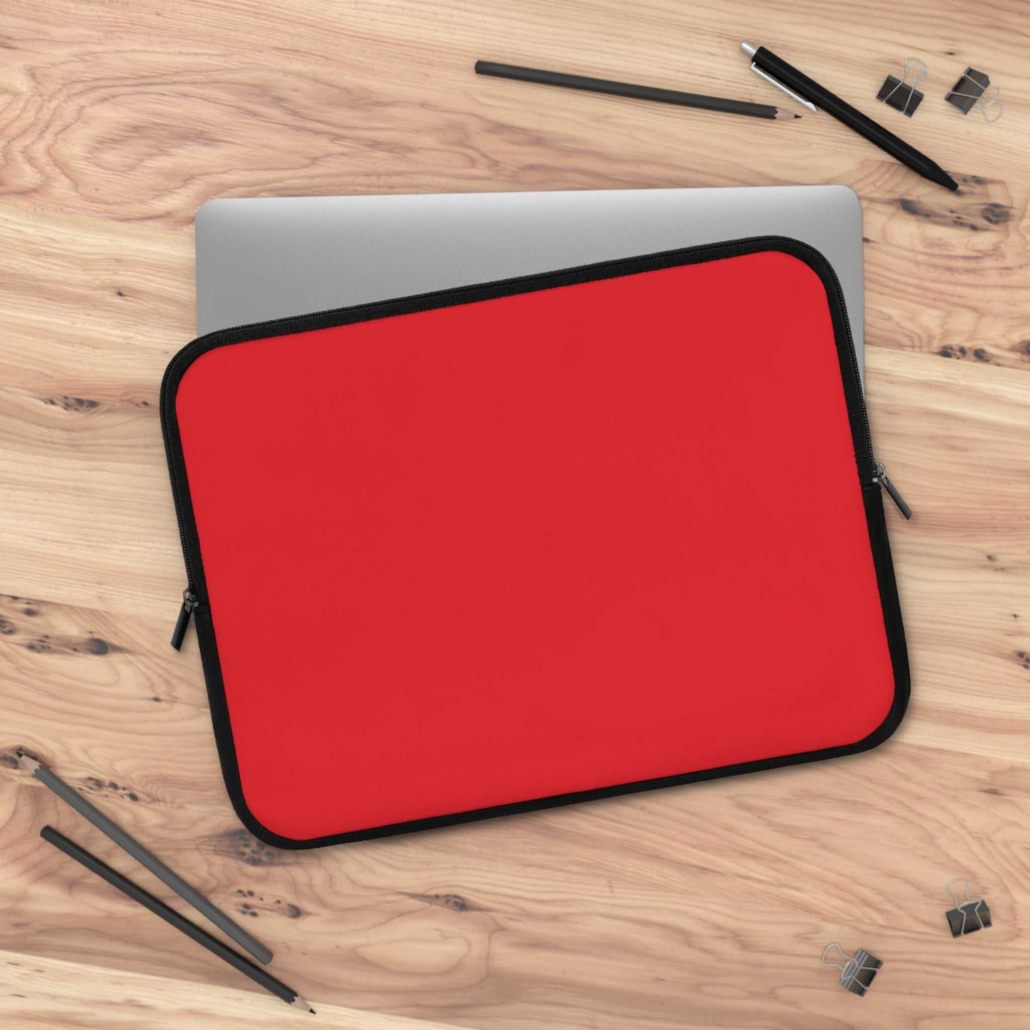 Red neoprene laptop sleeve with soft foam lining, dual zipper, lightweight and waterproof design for protection and style.