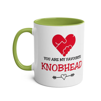 Favourite Knobhead Mug with playful red heart design, green handle, and interior.