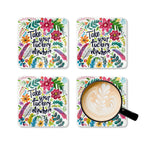 Colorful coaster set with cheeky "Take Your Fuckery Elsewhere" design, includes four pieces, high-gloss MDF top, cork backing, and playful floral pattern.