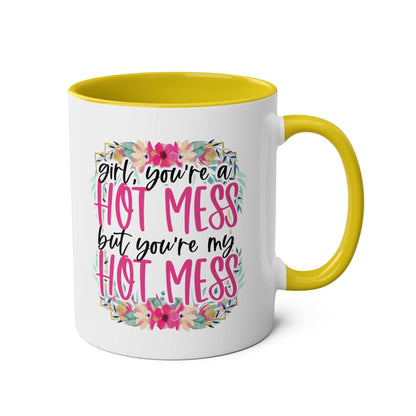 White ceramic coffee mug with yellow handle and interior, featuring floral design and "Girl, you're a Hot Mess but you're my Hot Mess" text.