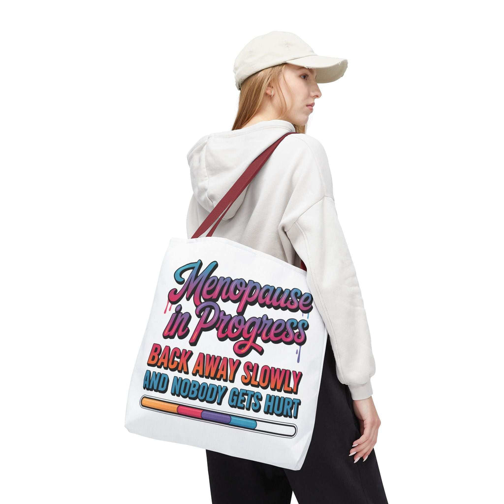 Menopause in Progress tote bag with cheeky design, durable spun polyester, multiple sizes and handle colors, perfect for casual outings