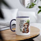 Cute sloth coffee mug with whimsical design on a wooden table.