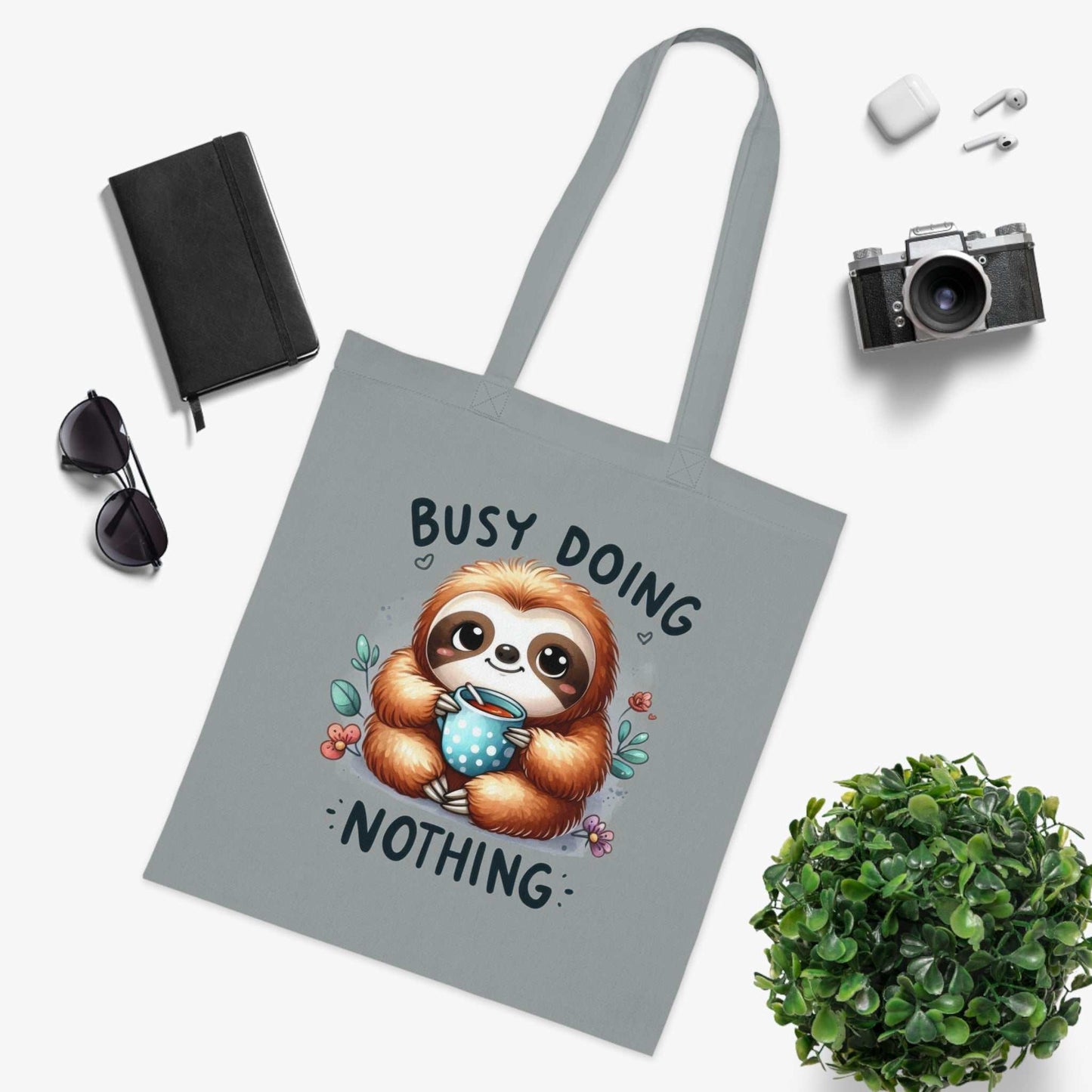 Cotton tote bag with cute sloth design, vibrant colors, and reinforced stitching.