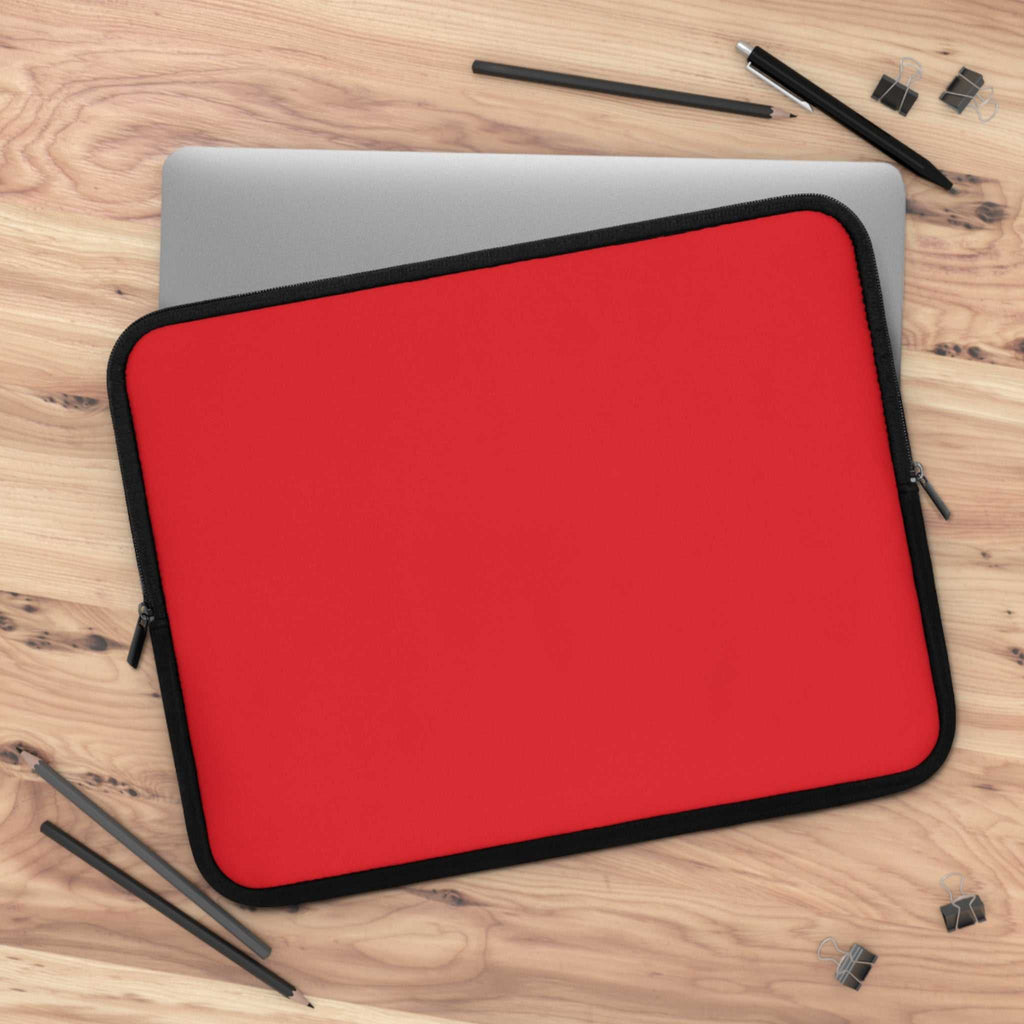 Red neoprene laptop sleeve with black trim, soft foam lining, dual zipper, lightweight, waterproof, fits most laptops.