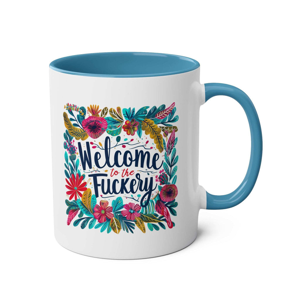 Colorful floral design "Welcome to the Fuckery" coffee mug with blue interior and handle.