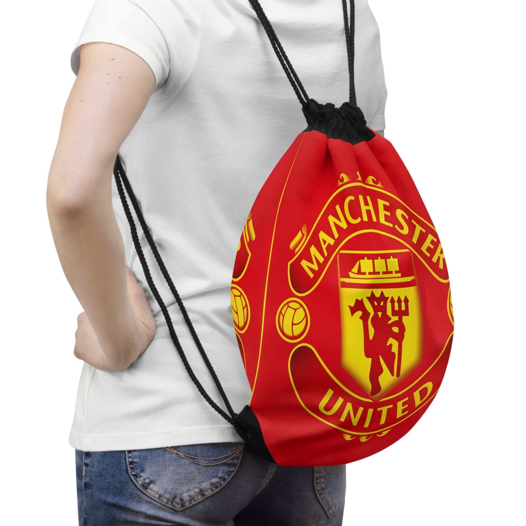 Manchester United drawstring bag in red and black with club crest, lightweight polyester, secure closure, and spacious interior for gym or travel