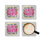 Colorful coaster set with "You are, like, really weird...and I love it" design, featuring floral accents.