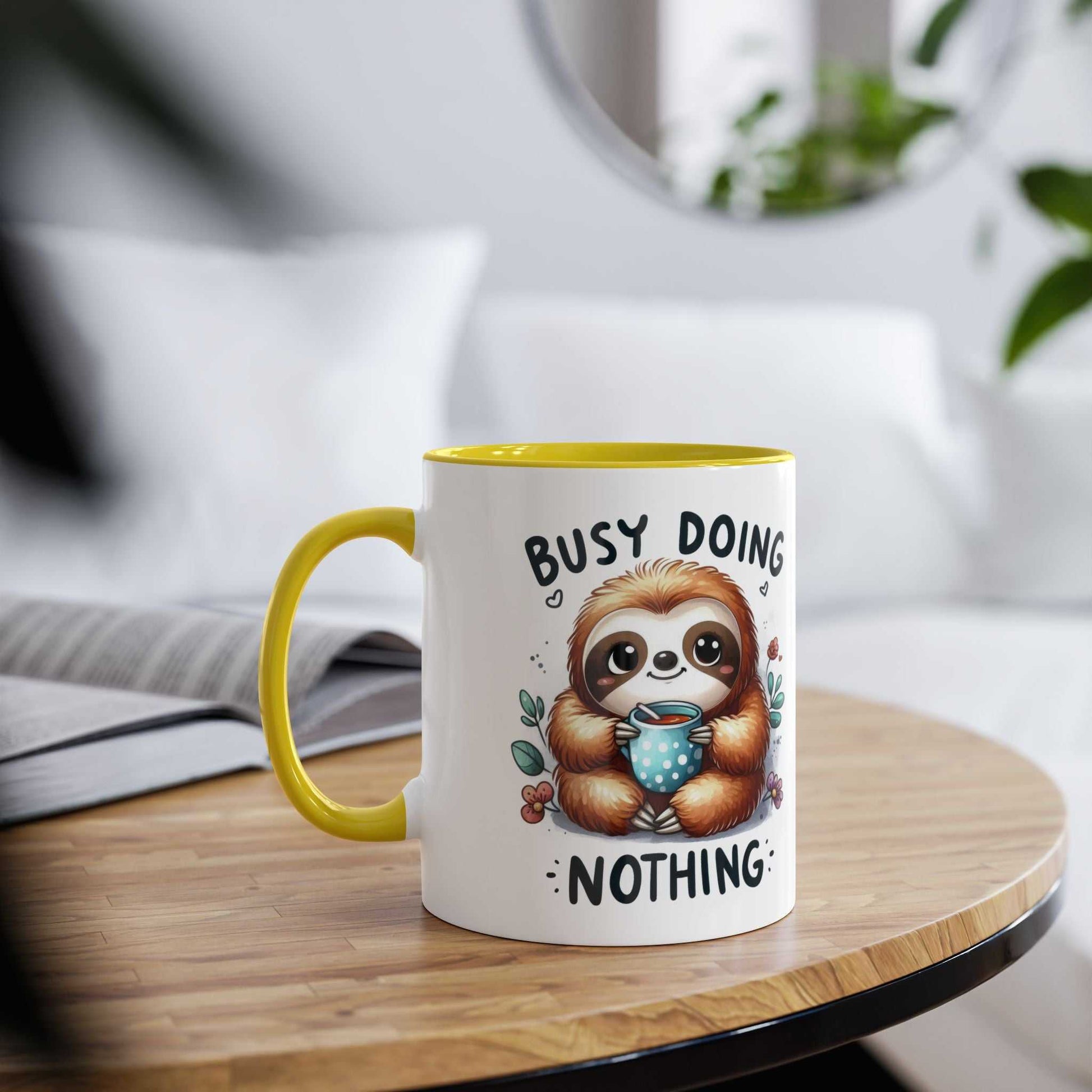 Cute sloth coffee mug with "busy doing nothing" text, yellow handle, 11oz ceramic, cheerful design.