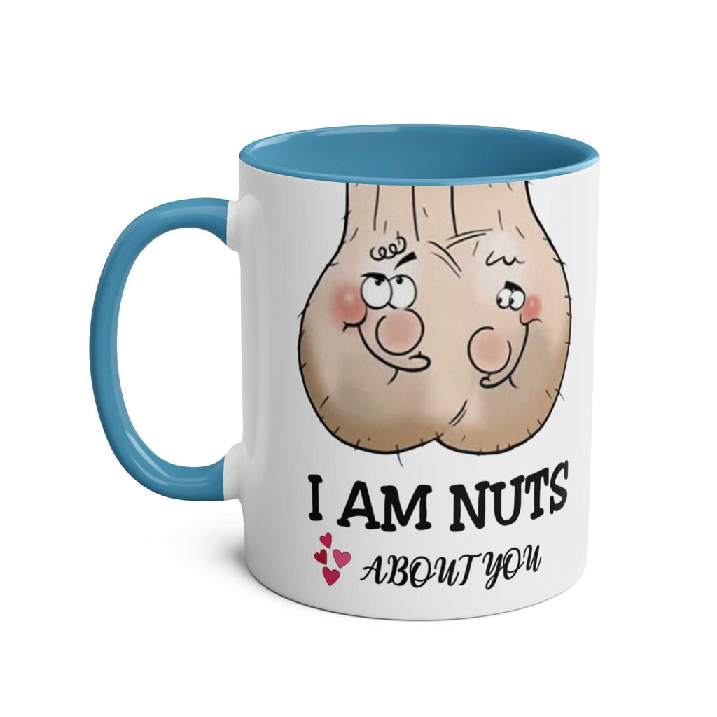 White ceramic "I Am Nuts About You" mug with blue handle and interior, featuring playful nut cartoon design and cheeky text, dishwasher safe.