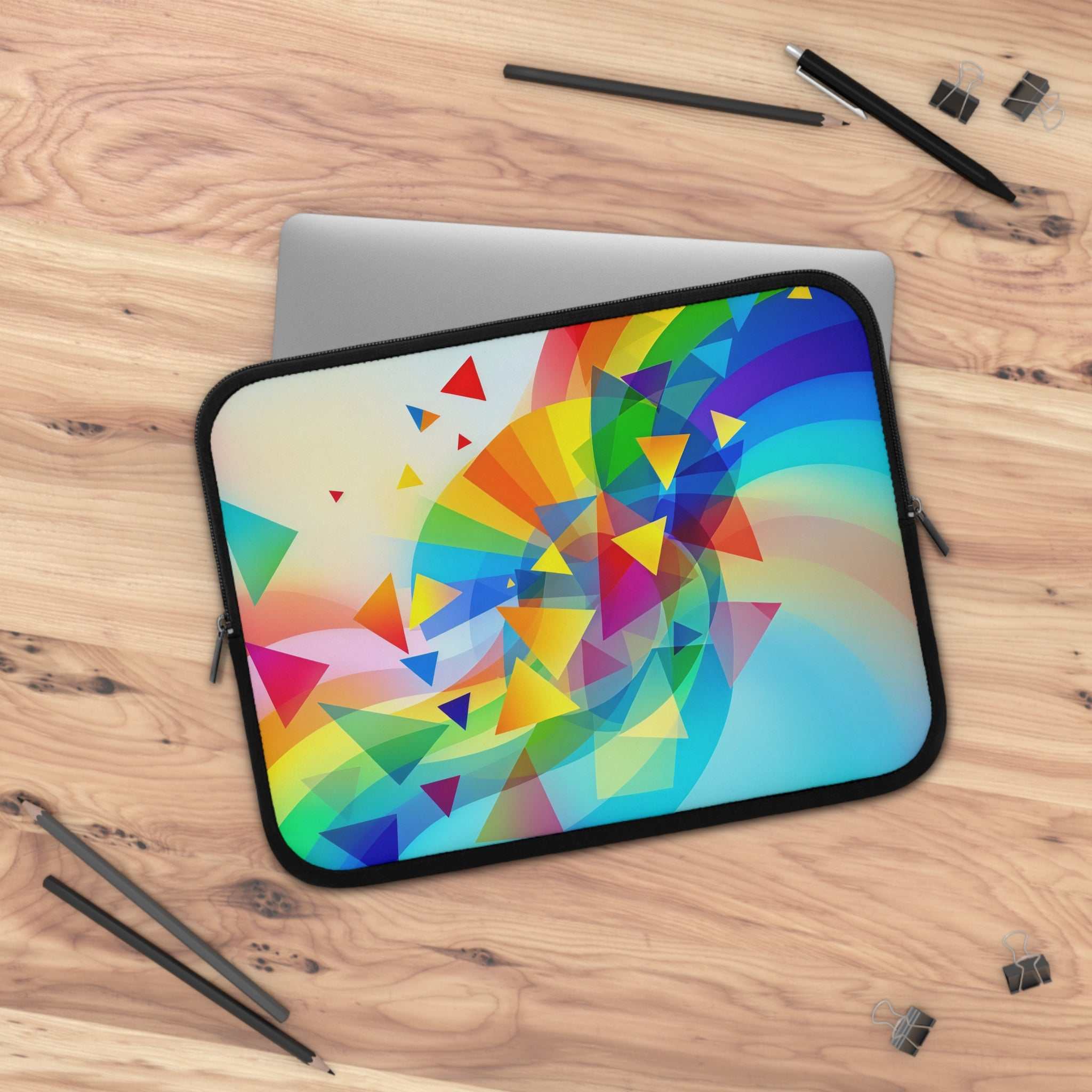 Colorful geometric pride design laptop sleeve with dual zipper on wooden desk