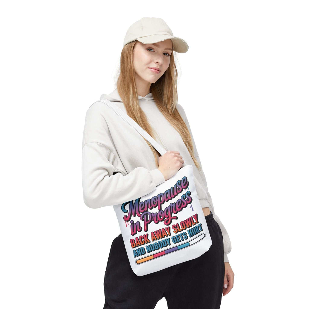 Menopause in Progress tote bag with cheeky design, durable spun polyester, multiple sizes and handle colors, reusable and lightweight
