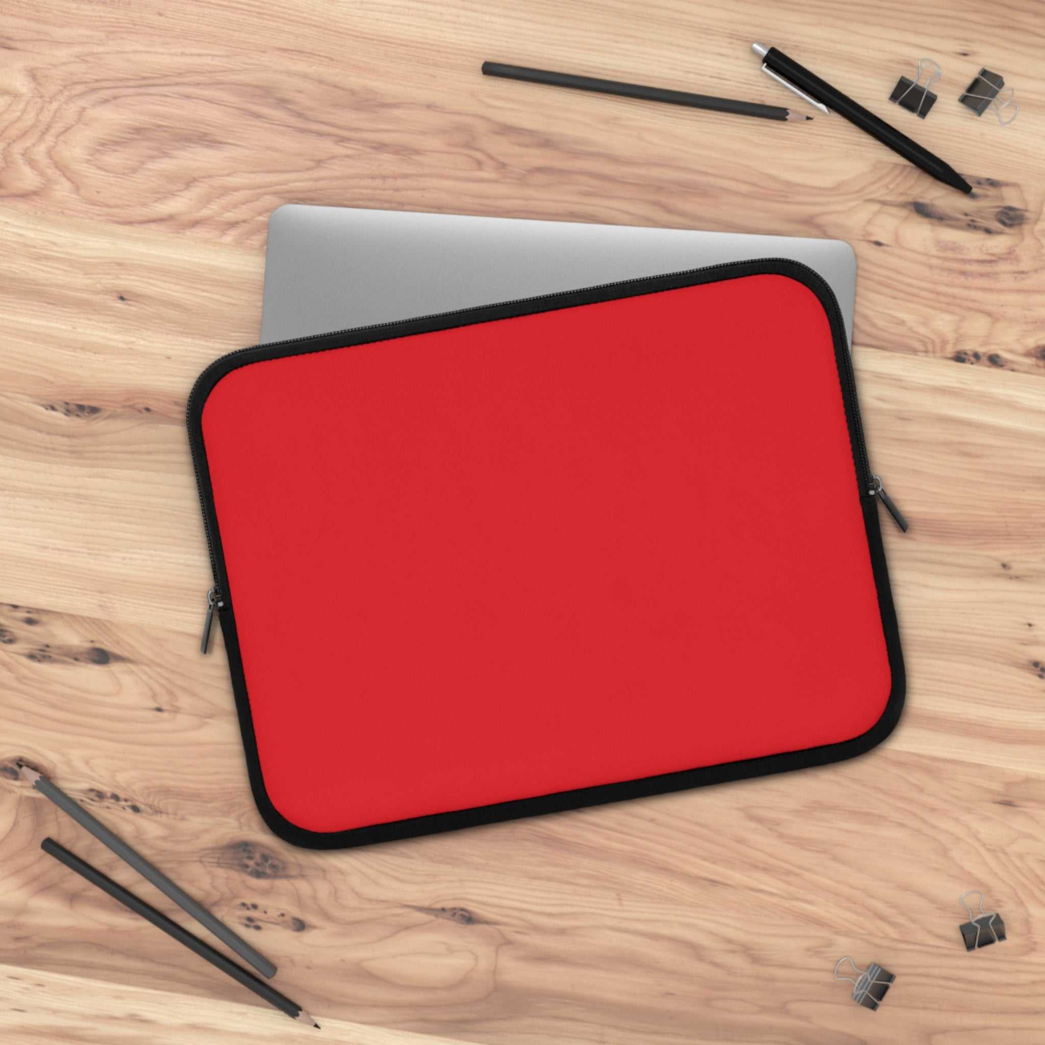 Red neoprene laptop sleeve with dual zipper and soft foam lining for protection and easy access.