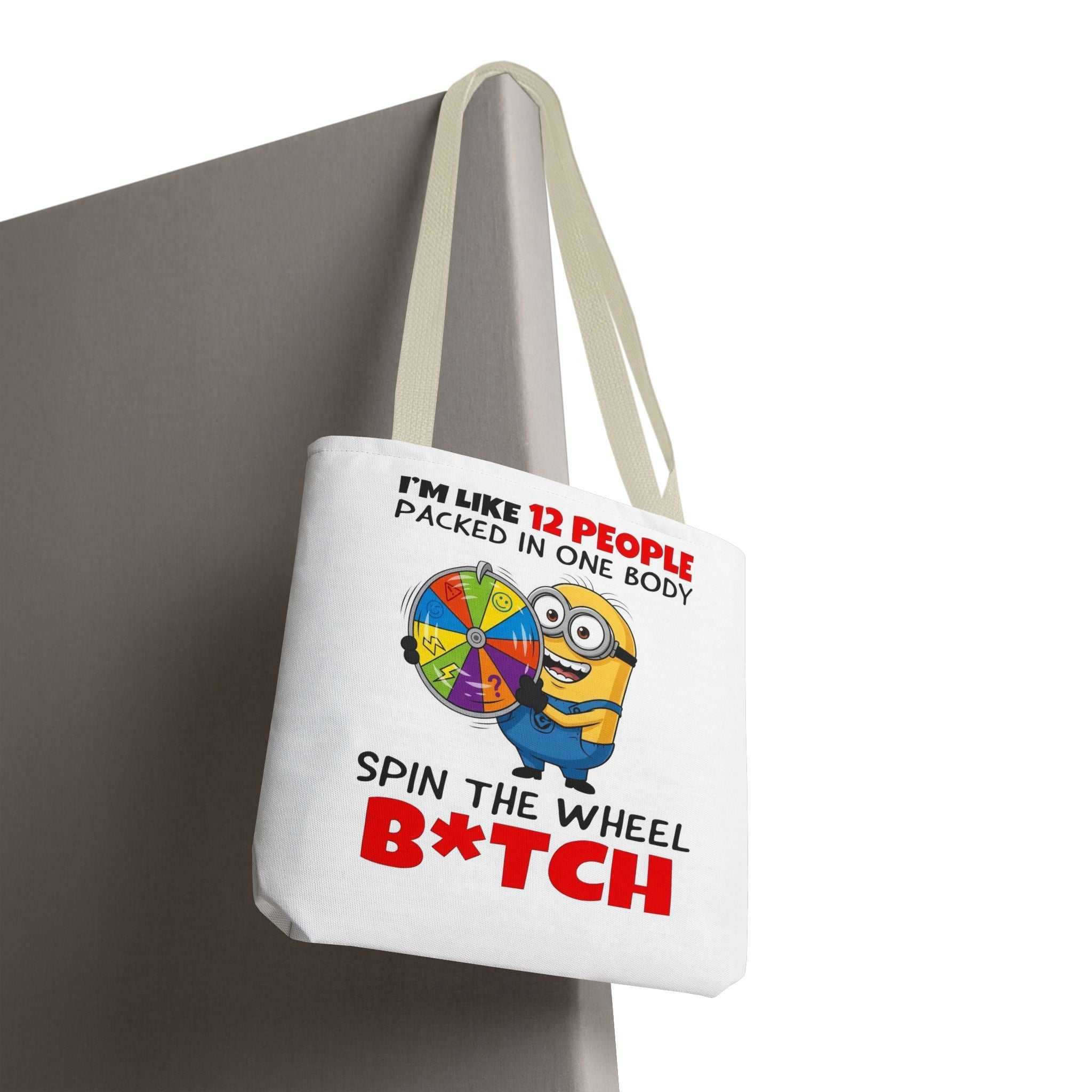 Funny Minion tote bag with cheeky design, durable spun polyester, available in three sizes and multiple handle colors