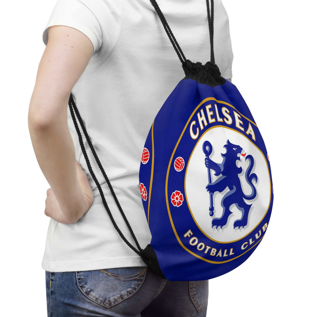 Person wearing a Chelsea FC drawstring bag in blue with lion crest, ideal for sports and casual use