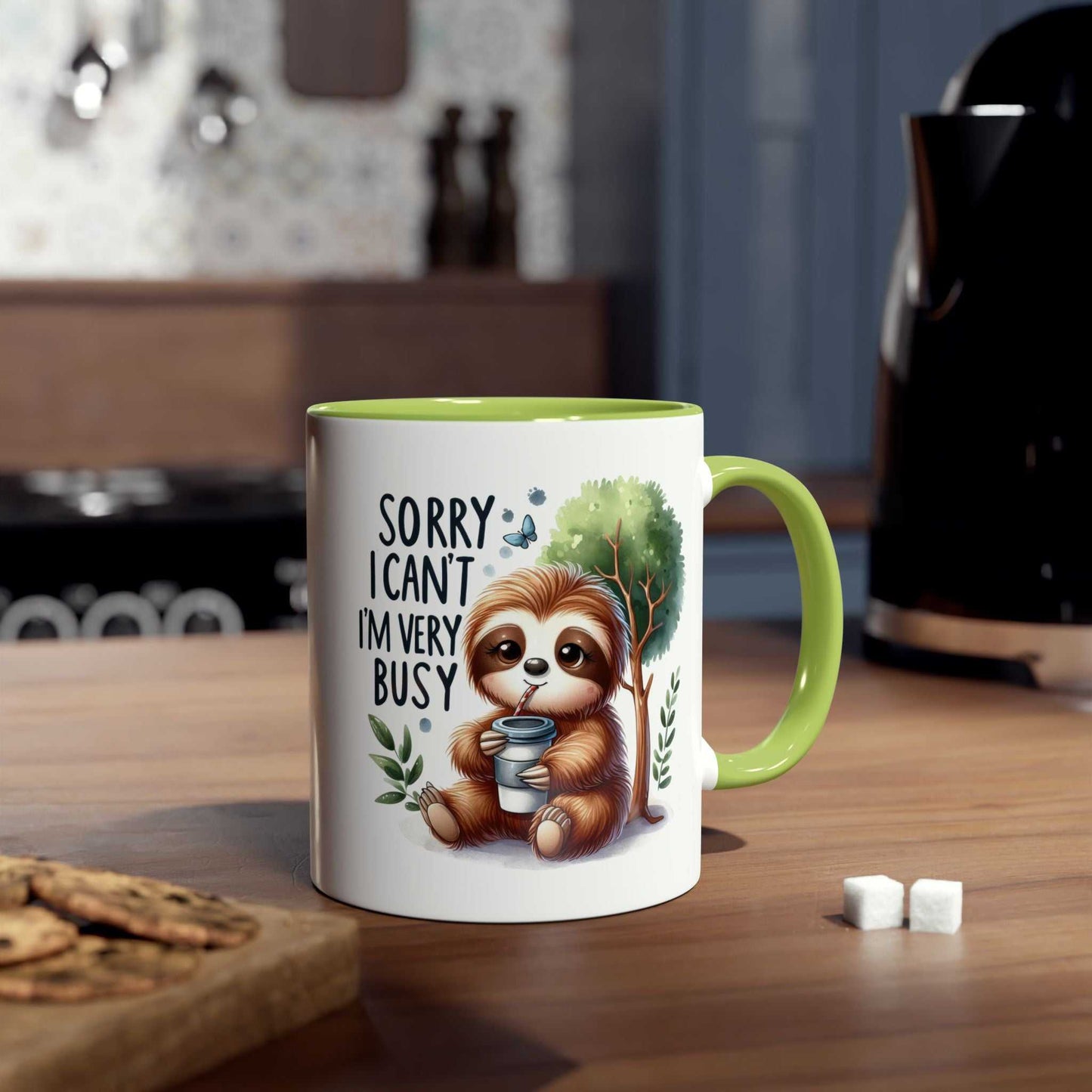 Cute sloth coffee mug with whimsical design in kitchen setting, featuring a green handle.