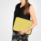 Woman holding lemon yellow laptop sleeve made of durable neoprene with soft foam lining and dual zipper closure