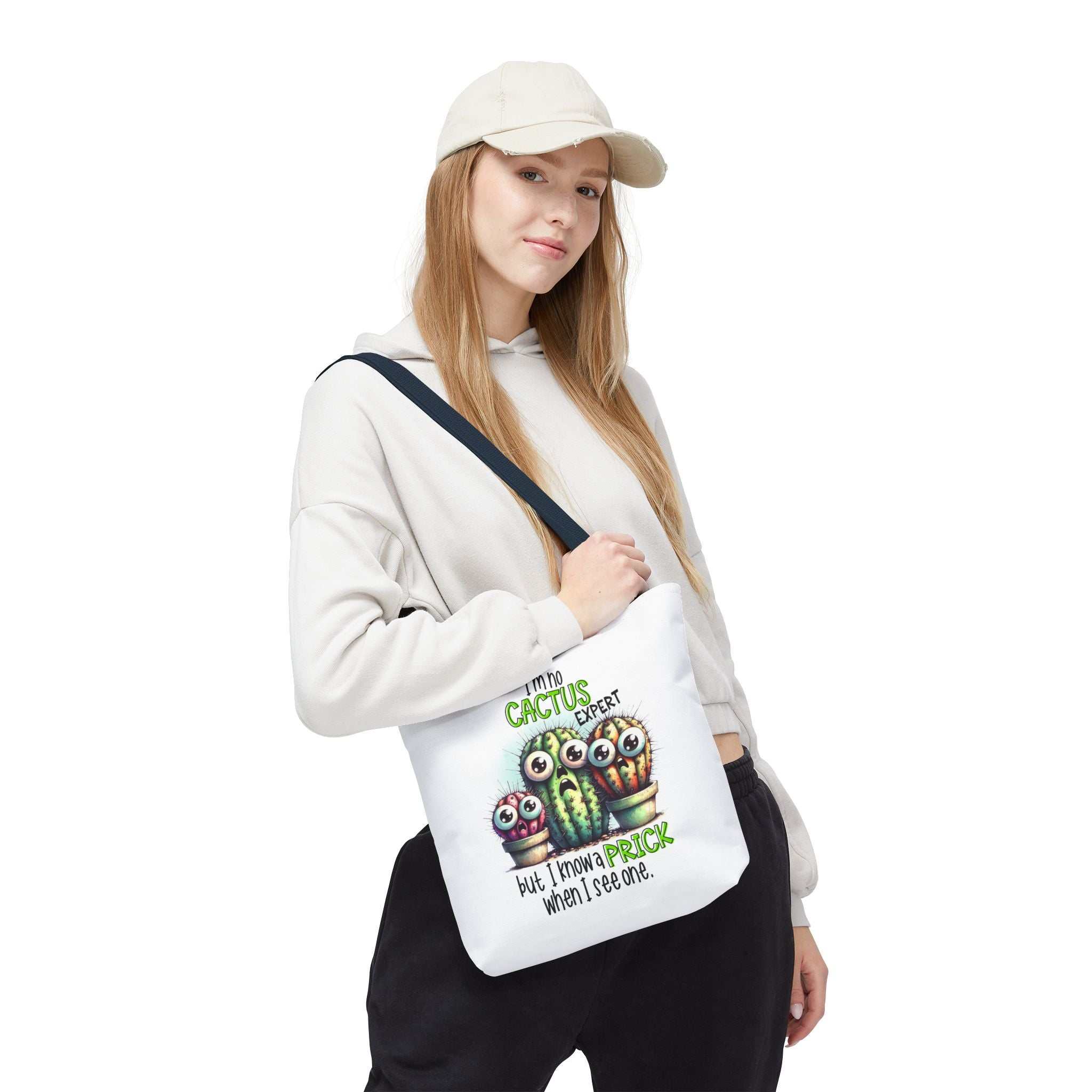 Fun cactus tote bag with cheeky design, durable spun polyester, available in three sizes and multiple handle colors.