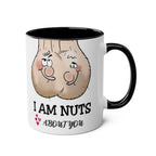 Cheeky white ceramic mug with "I Am Nuts About You" design, black handle and rim.