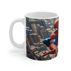 White ceramic mug featuring vibrant Spider-Man superhero comic design swinging over cityscape, 11oz, glossy finish, microwave and dishwasher safe.