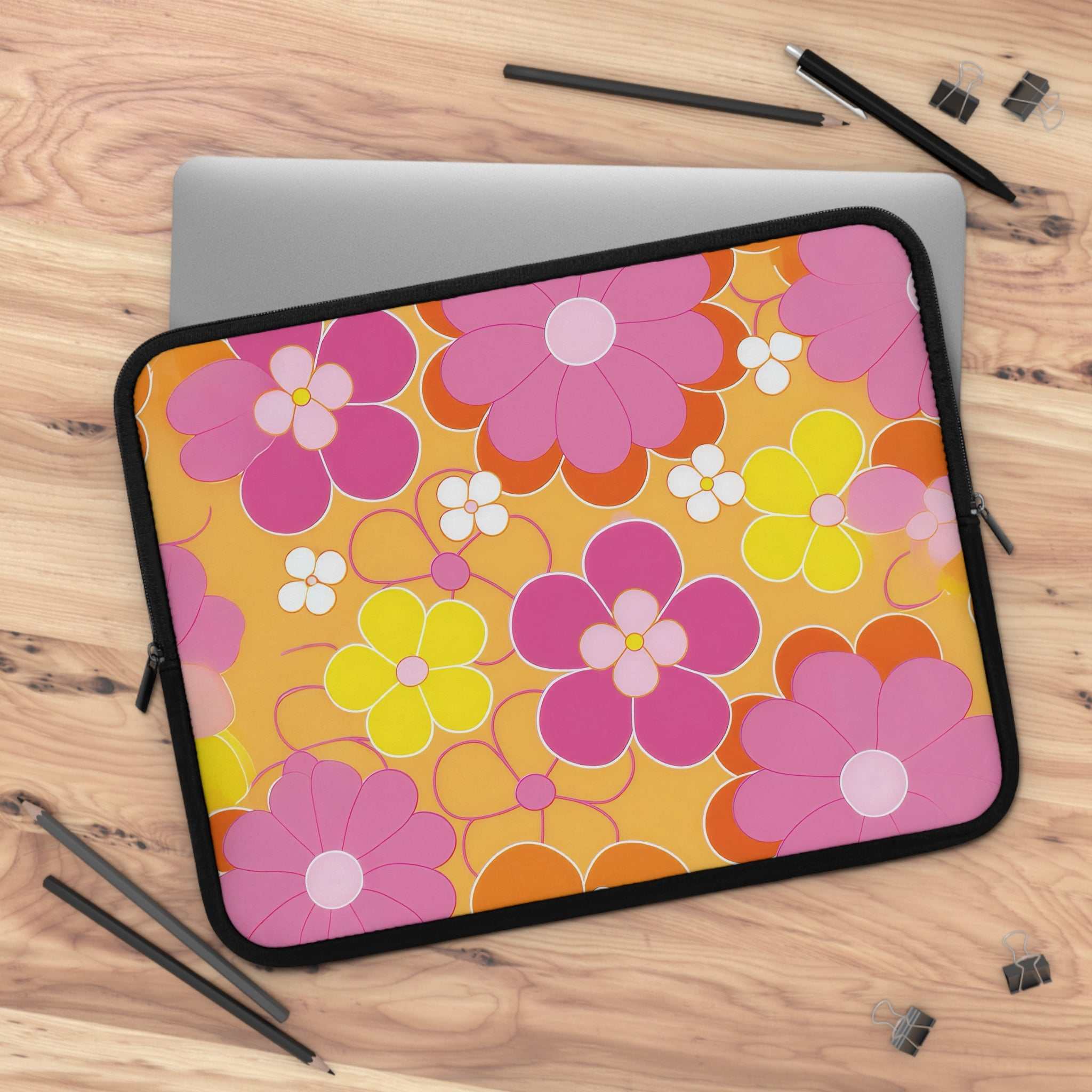 Retro floral laptop sleeve with colorful pink, yellow, and orange flowers on a yellow background, made of durable neoprene with dual zipper protection.