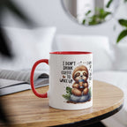 Cute sloth coffee mug with cheerful design and red handle on a wooden table.