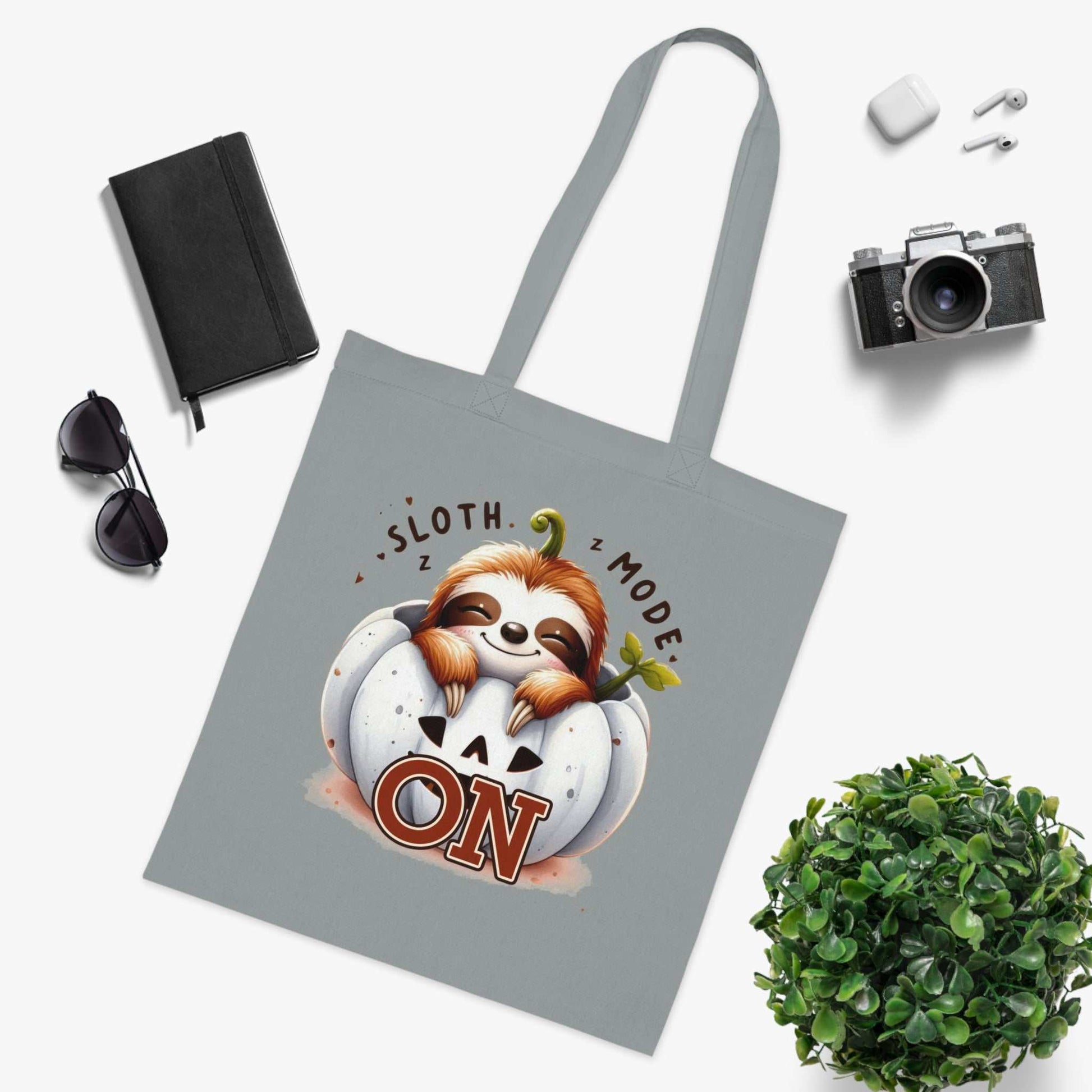 Cotton tote bag with cute sloth design and vibrant colors.