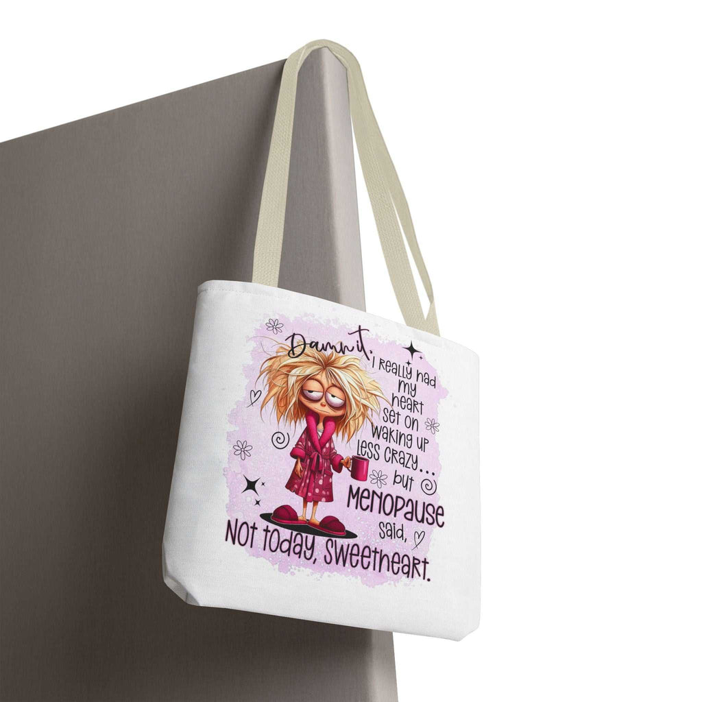 Menopause humour tote bag with cheeky printed design, durable spun polyester, available in three sizes and multiple handle colors