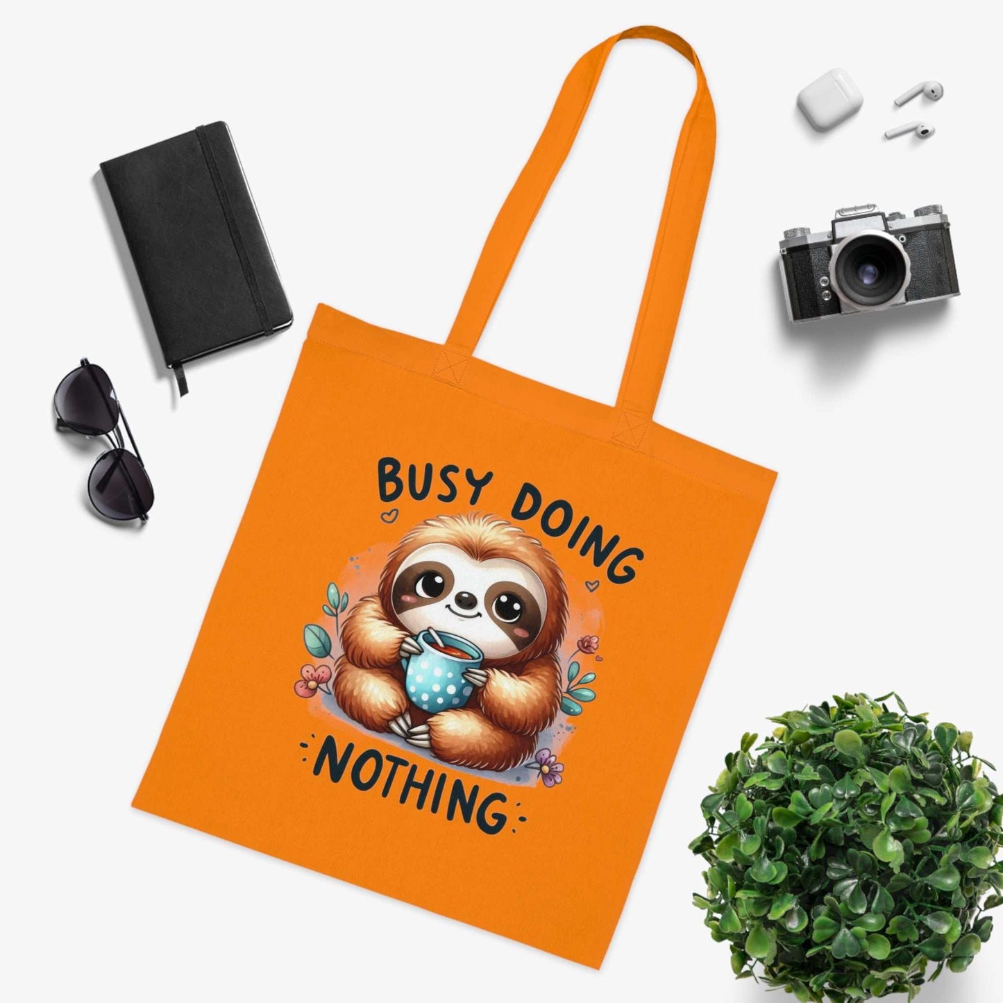 Cute sloth tote bag with vibrant orange color, perfect for carrying essentials.