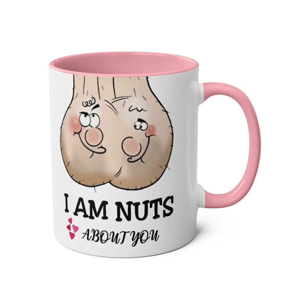 White ceramic "I Am Nuts About You" mug with pink handle and rim featuring cheeky cartoon nuts design