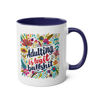 Colorful "Adulting Is Bullshit" coffee mug with floral design and glossy finish.