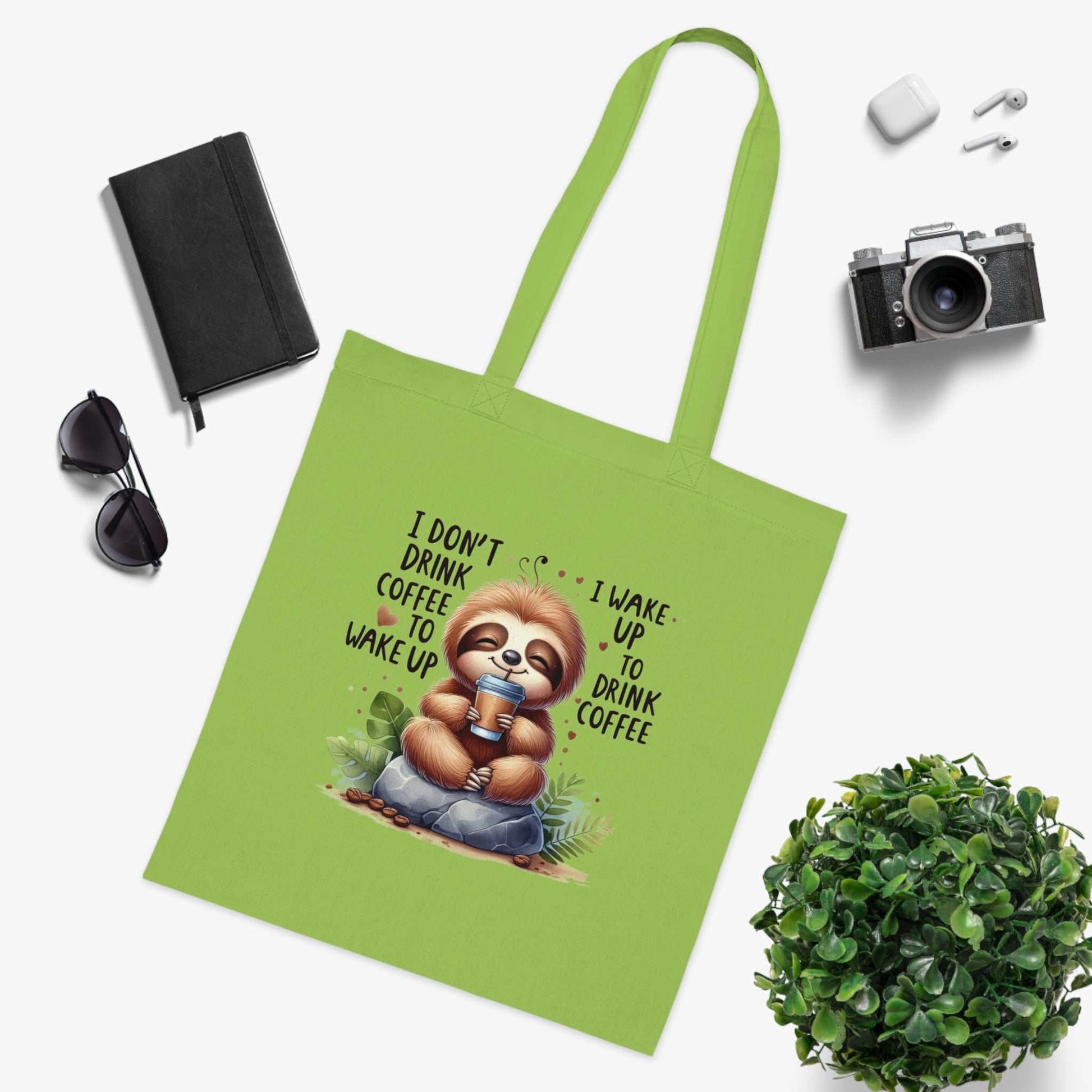 Cotton tote bag with cute sloth design and coffee-themed text, fun and playful accessory for sloth lovers.