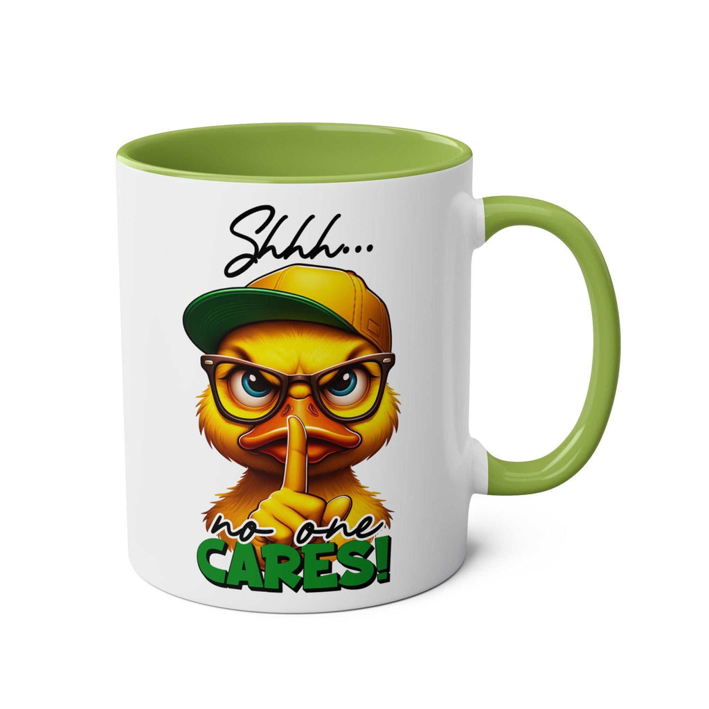 Duck design "No One Cares" coffee mug with green handle.