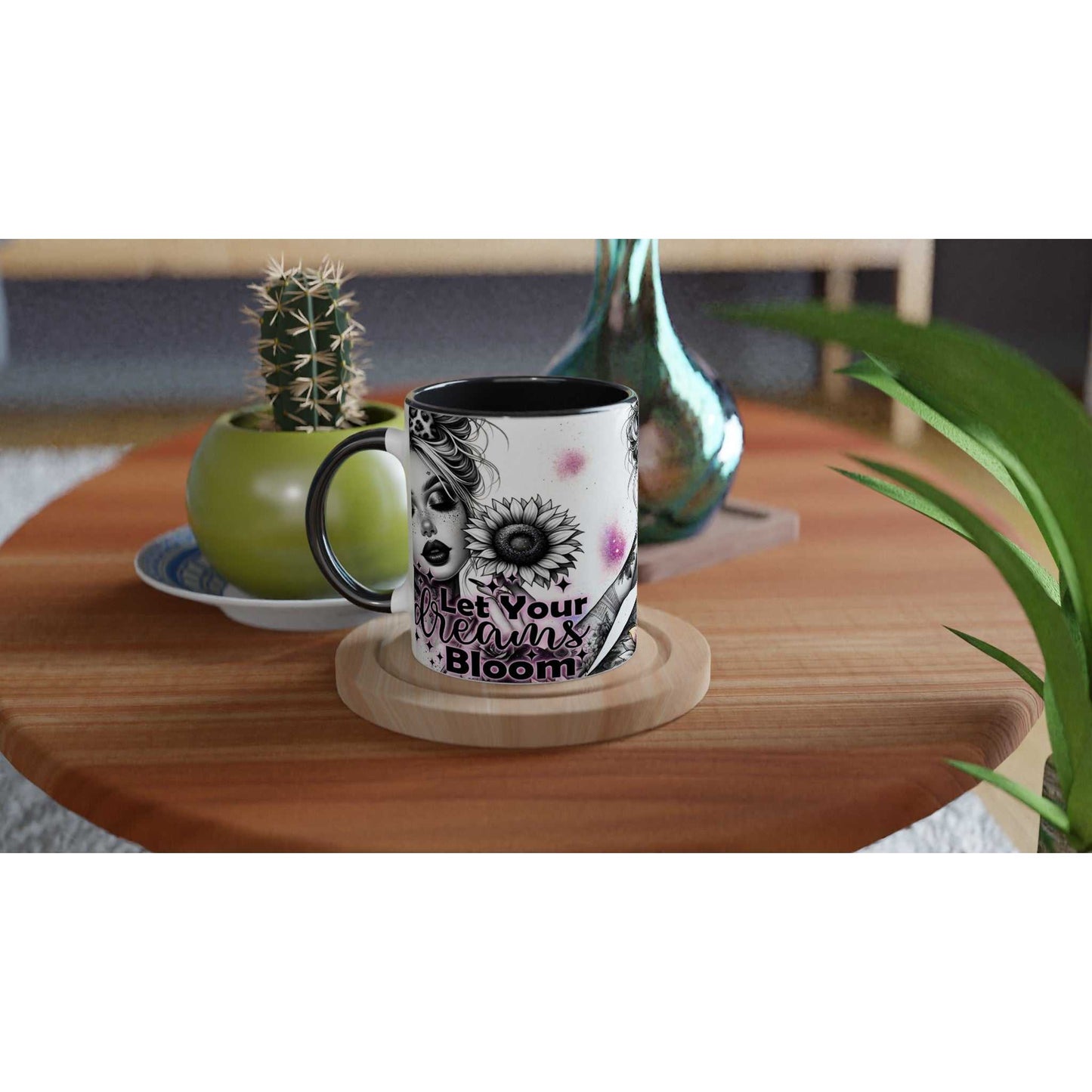 Let Your Dreams Bloom motivational coffee mug on a wooden table with plants.