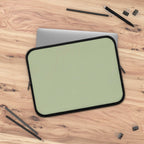 Sage green neoprene laptop sleeve with black trim, soft foam lining, dual zipper, waterproof and lightweight protection for laptops