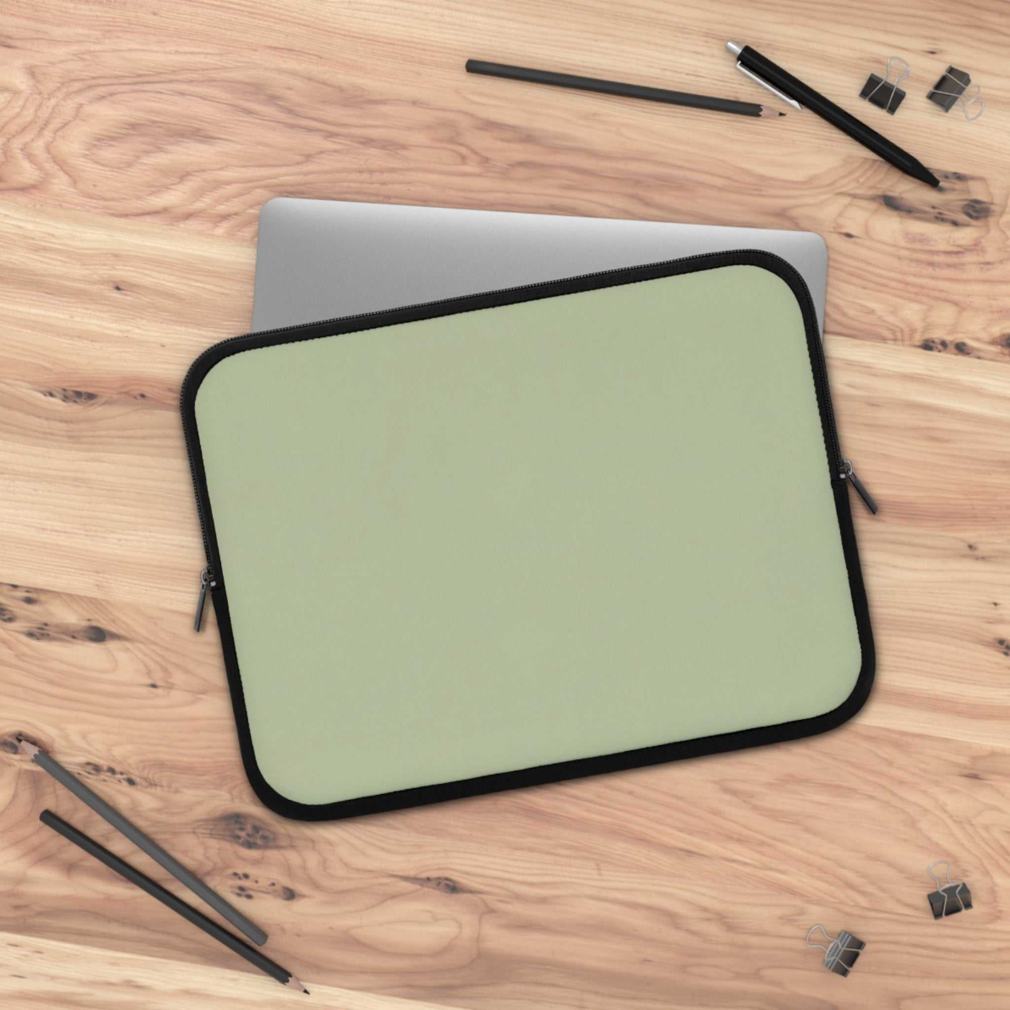 Sage green neoprene laptop sleeve with black trim, soft foam lining, dual zipper, waterproof and lightweight protection for laptops