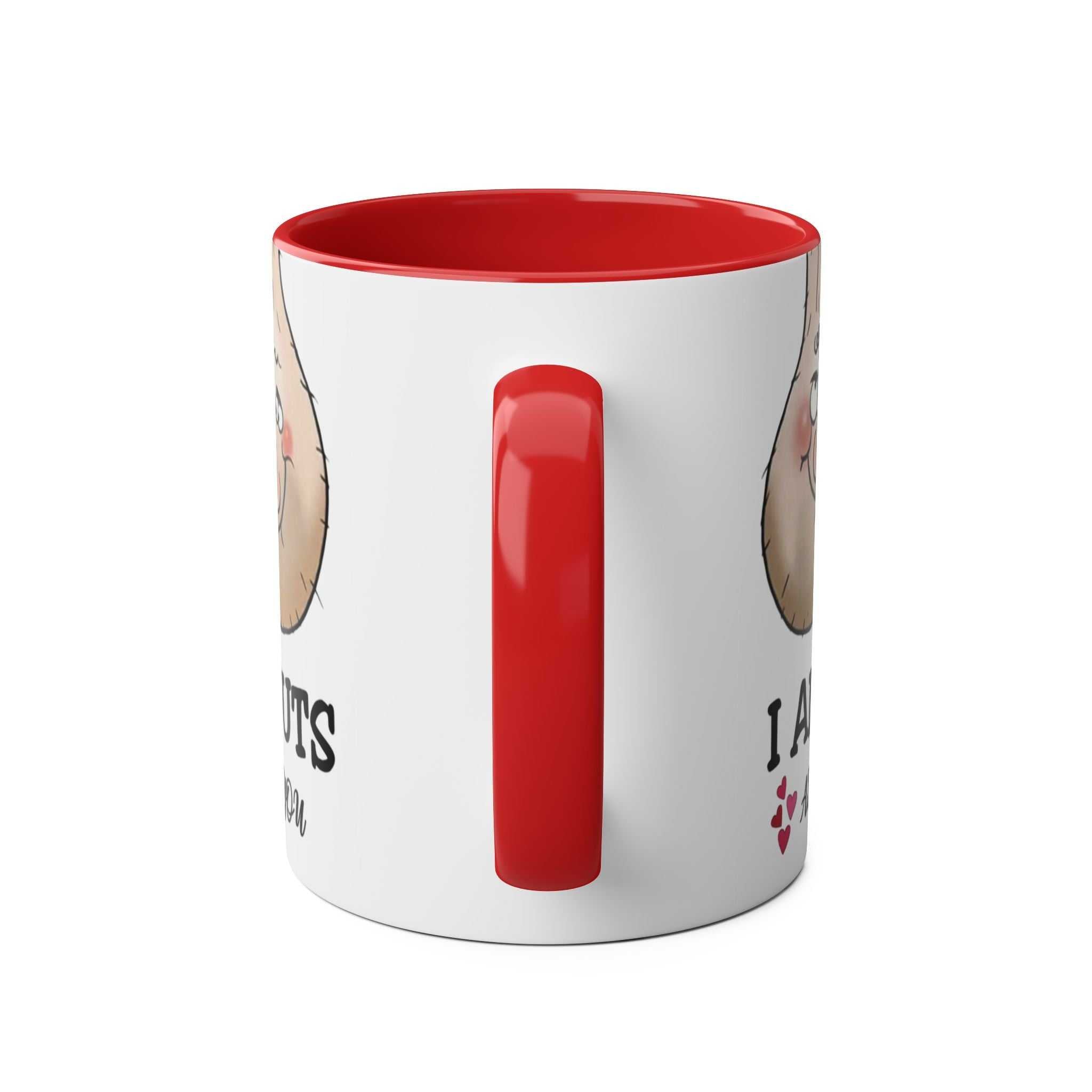 Glossy red-handled ceramic mug with "I Am Nuts About You" design, 11oz capacity, perfect for hot beverages.