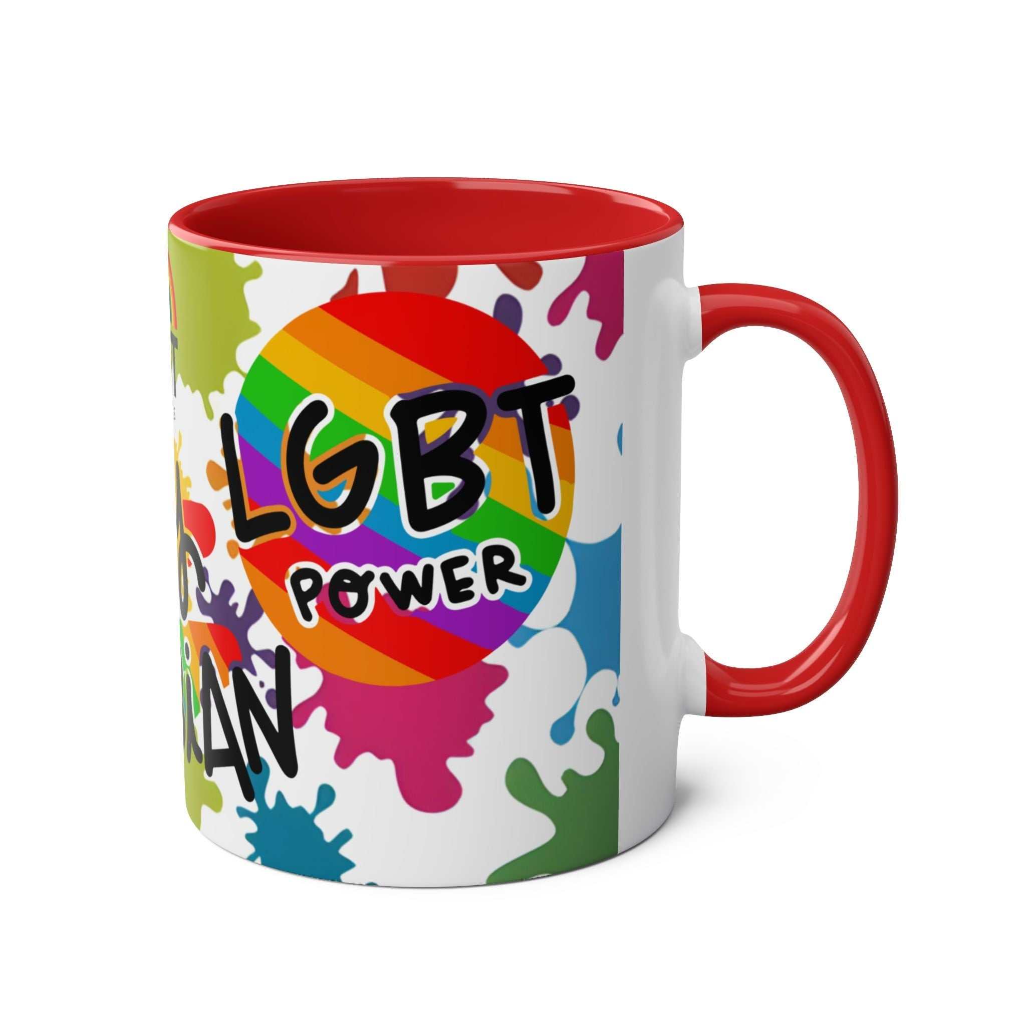 LGBTQ+ Pride mug with vibrant rainbow design and red handle.