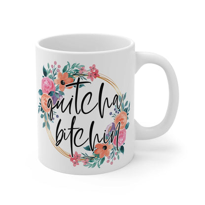 White ceramic mug with colorful floral wreath and "quitcha bitchin" text in black cursive, glossy finish, 11oz Quitcha Bitchin Ceramic Mug