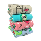 Stack of four colorful mid-calf cocktail-themed socks from Socktails Gift Set Gin Edition with playful gin designs and sparkle accents