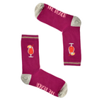 Bright pink mid-calf socks with grey heel and toe, cocktail drink design, and "The Beach" text, part of the Socktails Gift Set