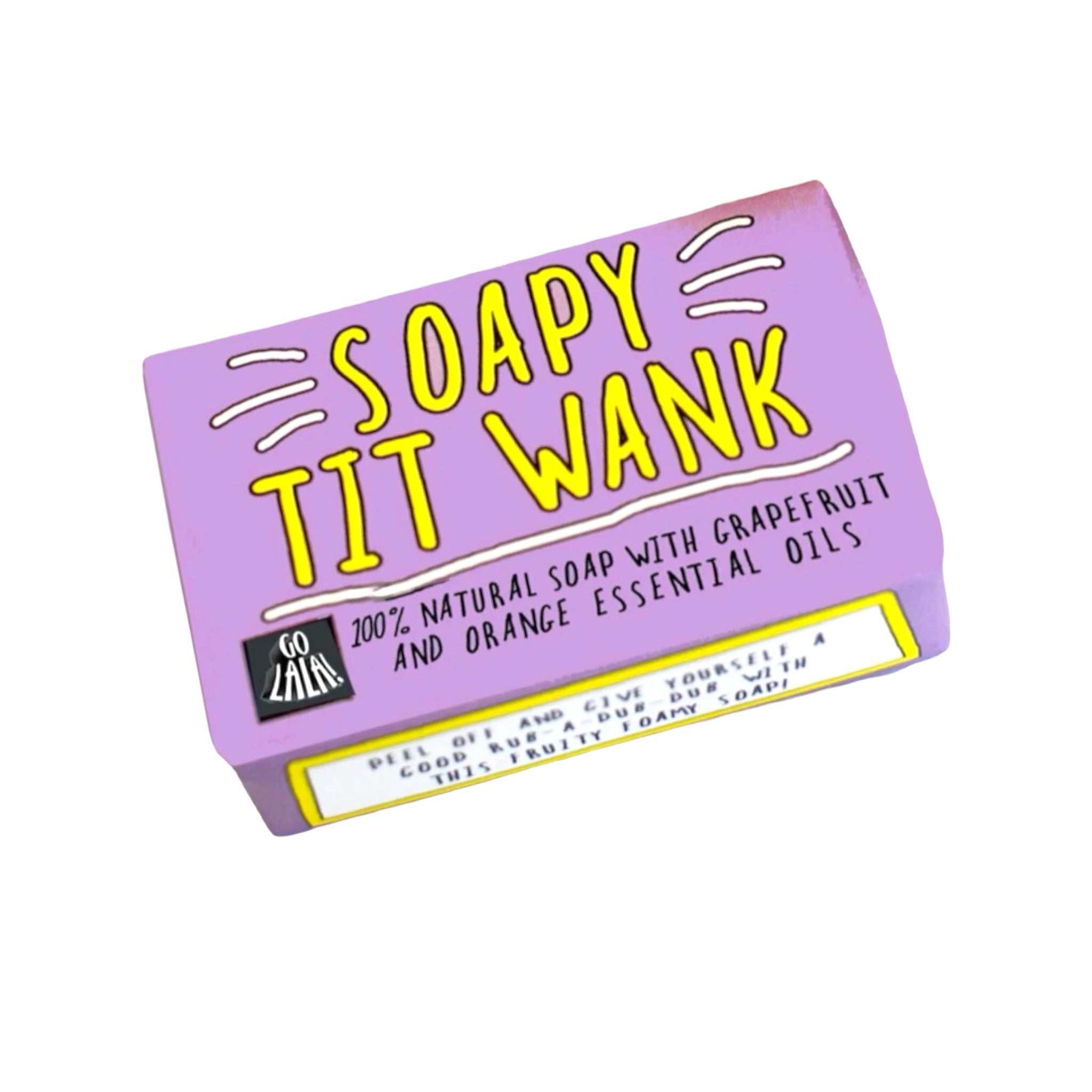 Soap bar labeled "Soapy Tit Wank" with grapefruit and orange scent on a purple package.
