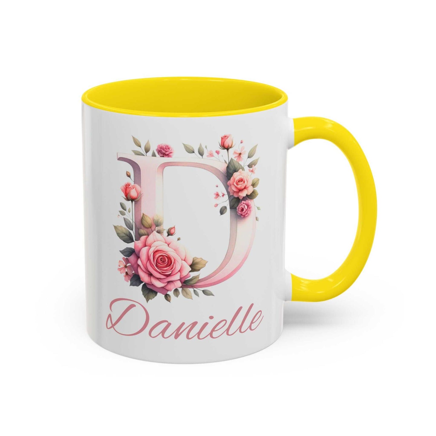 Personalised watercolour gift mug with floral design and custom name "Danielle" on a ceramic surface with yellow interior and handle.