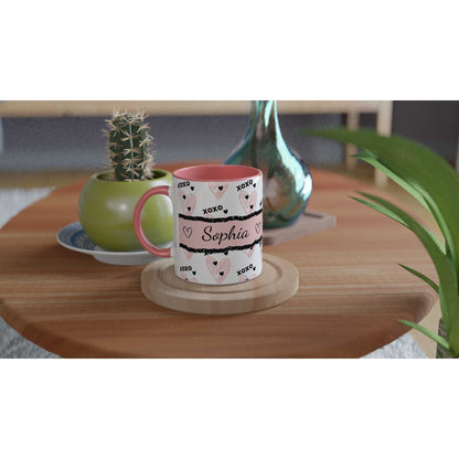 Personalised cute Valentines Day mug with heartwarming design and colored handle on a wooden table.