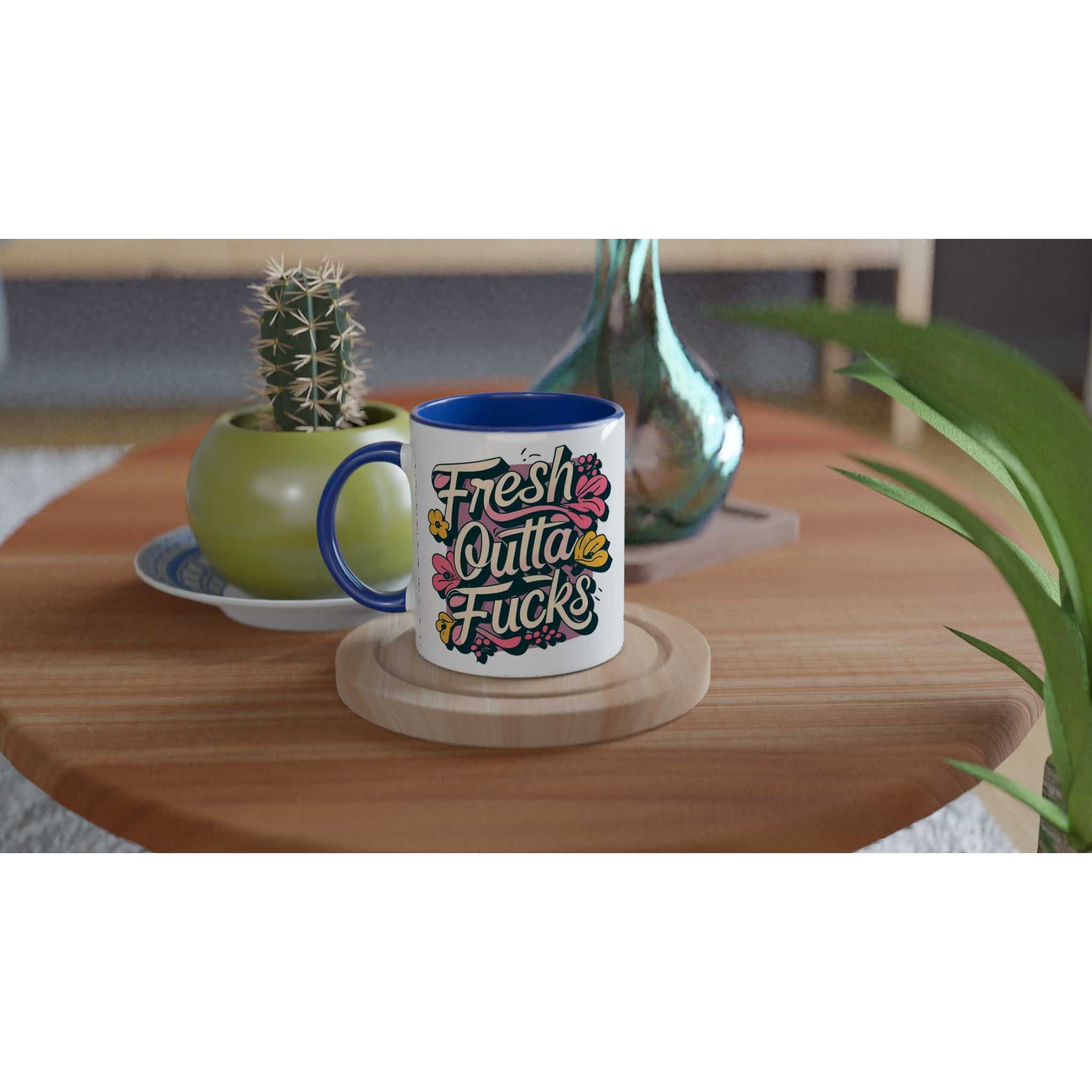 11oz Fresh Outta Fucks Fun Mug with colorful design on wooden table.